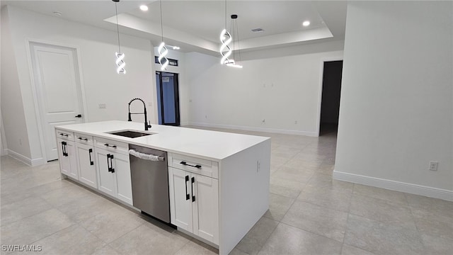 kitchen featuring stainless steel dishwasher, a tray ceiling, pendant lighting, and sink