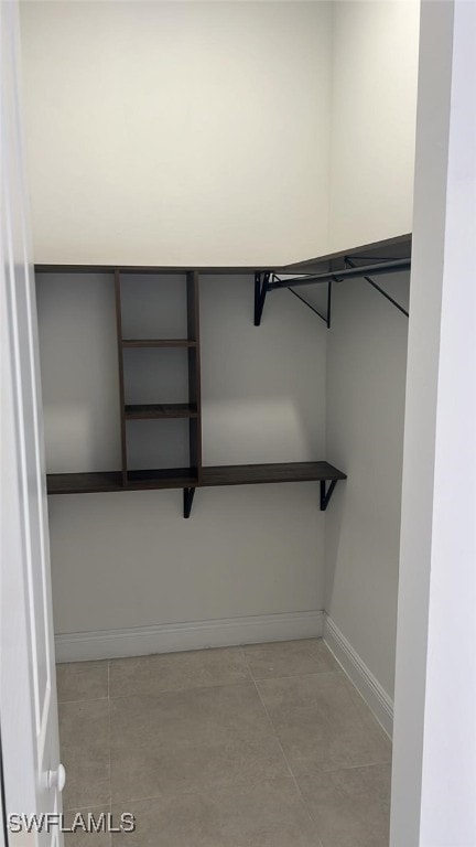 walk in closet featuring light tile patterned flooring