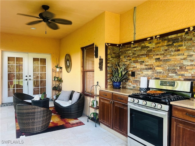 view of patio featuring ceiling fan, french doors, and an outdoor kitchen