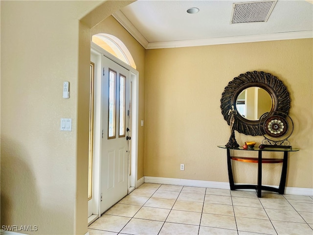 tiled foyer entrance featuring ornamental molding