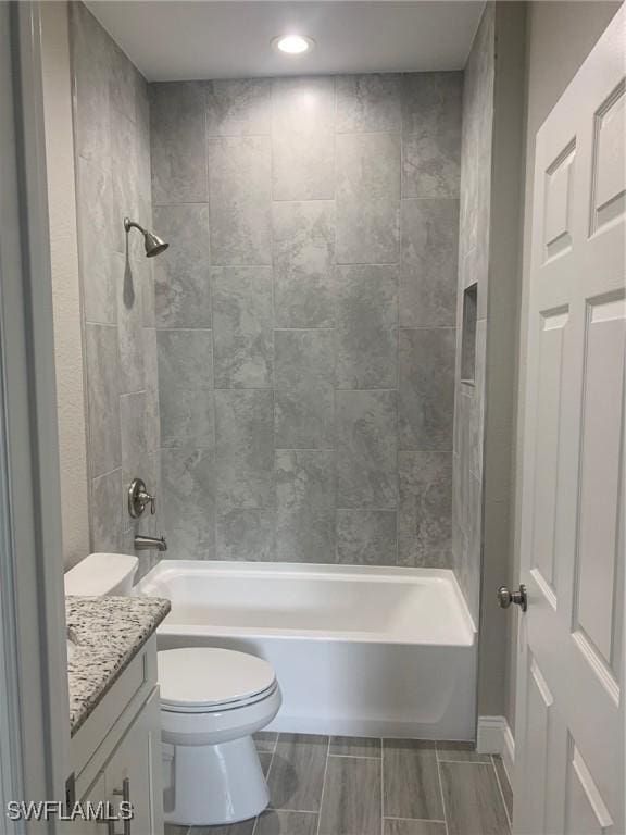 full bath featuring shower / washtub combination, toilet, and vanity