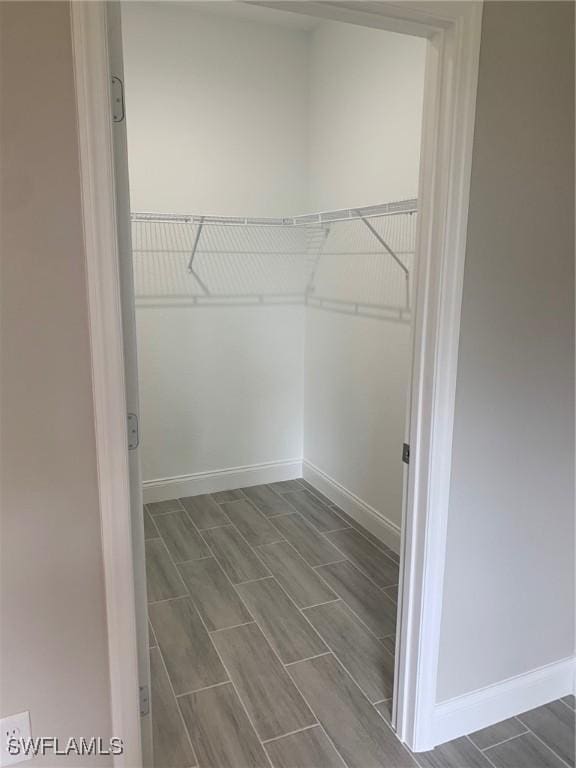 spacious closet with wood finish floors