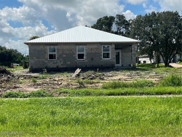 back of property featuring metal roof