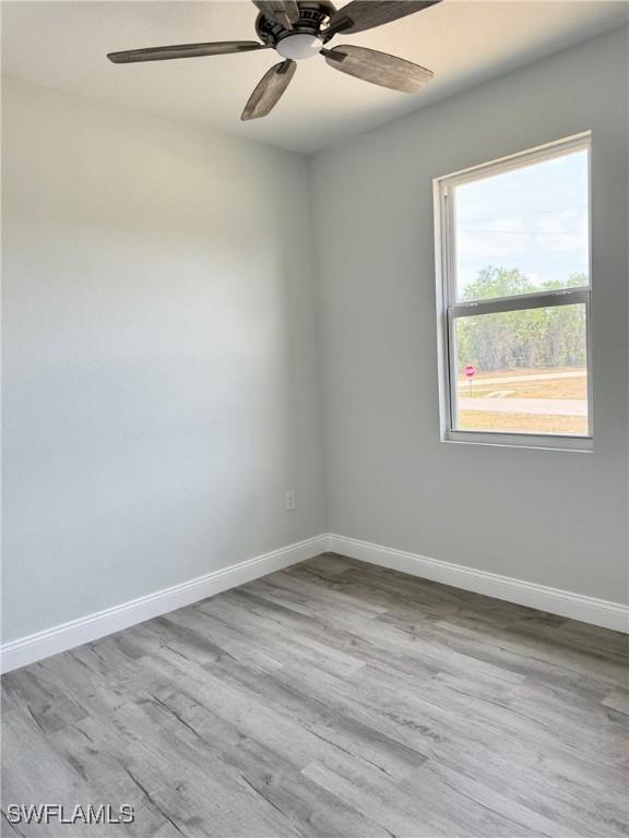 2001 Jeronimo Rd, Labelle, FL 33935 - empty room featuring baseboards, wood finished floors, and ceiling fan