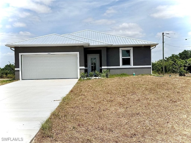2001 Jeronimo Rd, Labelle, FL 33935 - ranch-style home with stucco siding, concrete driveway, an attached garage, and metal roof