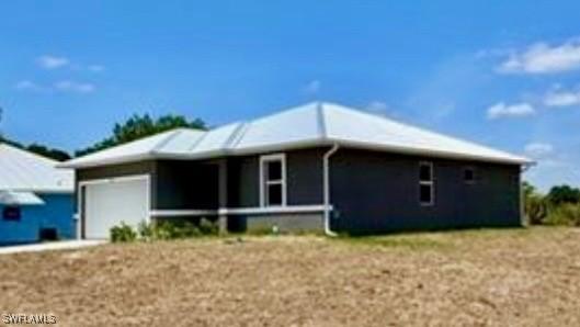 2001 Jeronimo Rd, Labelle, FL 33935 - view of front of home with an attached garage