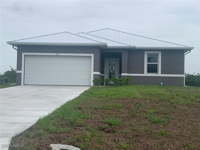 2001 Jeronimo Rd, Labelle, FL 33935 - ranch-style home featuring stucco siding, an attached garage, concrete driveway, metal roof, and a standing seam roof