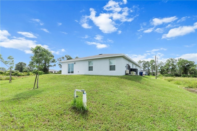 back of property featuring a yard