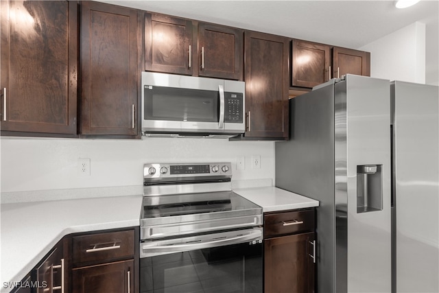 kitchen featuring dark brown cabinetry and stainless steel appliances