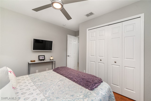 bedroom with ceiling fan, a closet, and light hardwood / wood-style floors