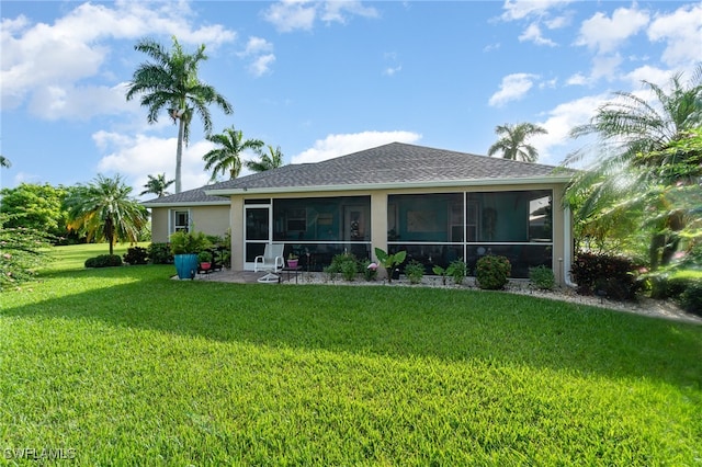 back of house with a lawn and a sunroom