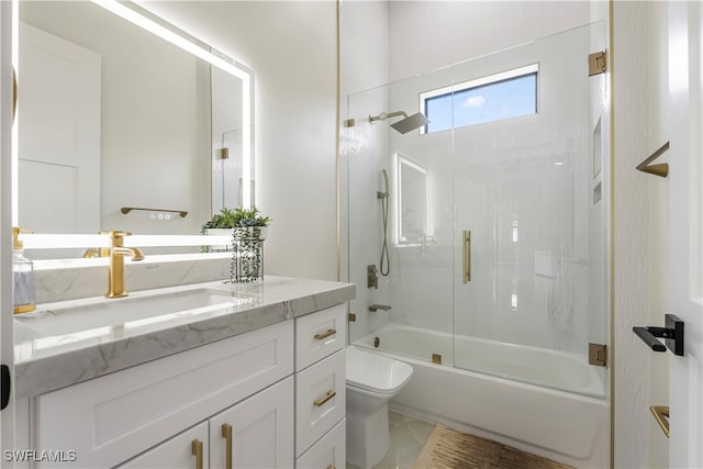 full bathroom featuring bath / shower combo with glass door, vanity, and toilet