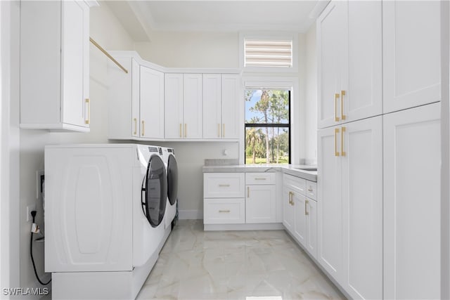 washroom featuring cabinets and washing machine and clothes dryer