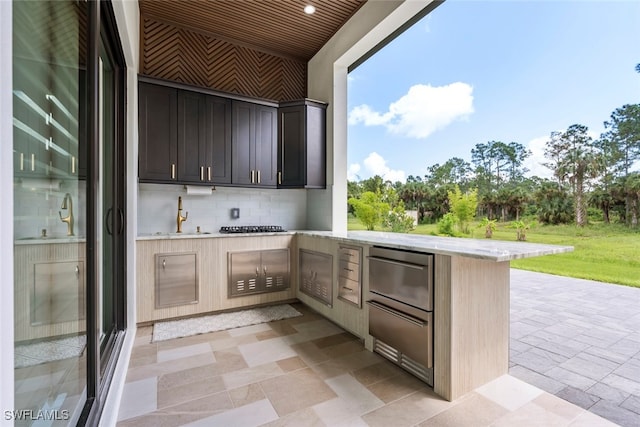 view of patio / terrace with exterior kitchen and sink