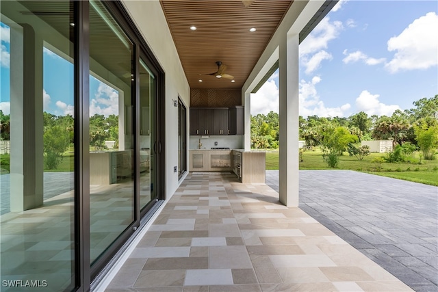 view of patio with area for grilling and ceiling fan