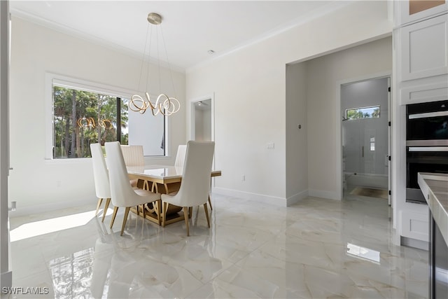 dining space with ornamental molding and a notable chandelier