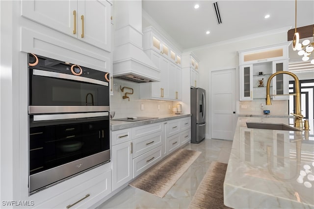 kitchen featuring backsplash, white cabinetry, and stainless steel appliances