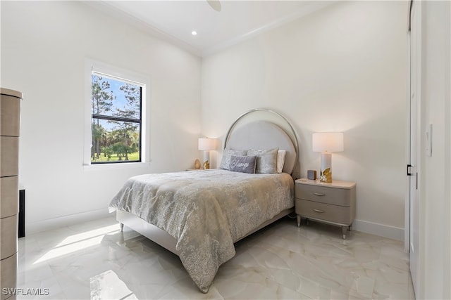 bedroom with ceiling fan and crown molding