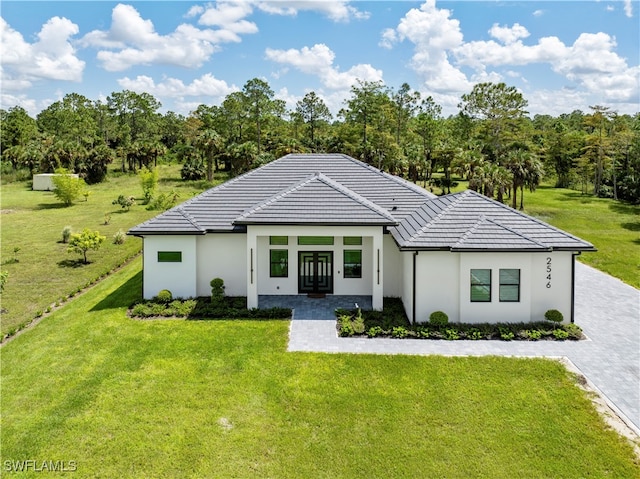 view of front of house featuring french doors and a front lawn