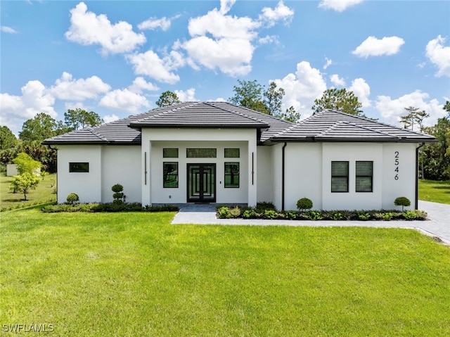 rear view of property featuring a lawn