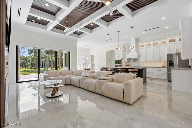 living room with beam ceiling, ceiling fan, and coffered ceiling