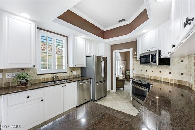 kitchen with stainless steel appliances, sink, and white cabinets