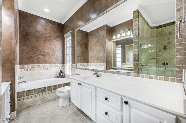 full bathroom with ornamental molding, separate shower and tub, tile patterned flooring, and vanity