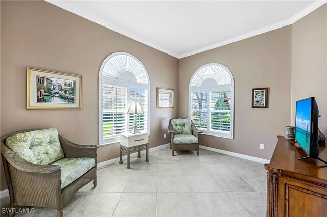 sitting room with light tile patterned floors and ornamental molding