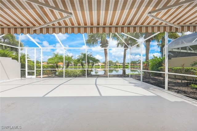 unfurnished sunroom featuring a water view