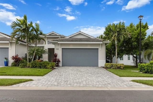 single story home with a front yard and a garage