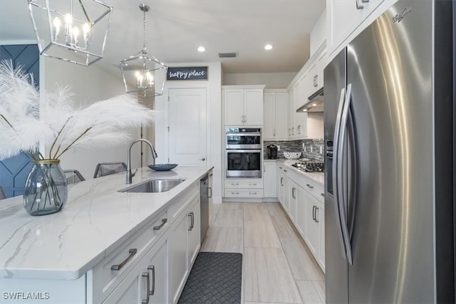 kitchen with sink, stainless steel appliances, a spacious island, decorative light fixtures, and white cabinets