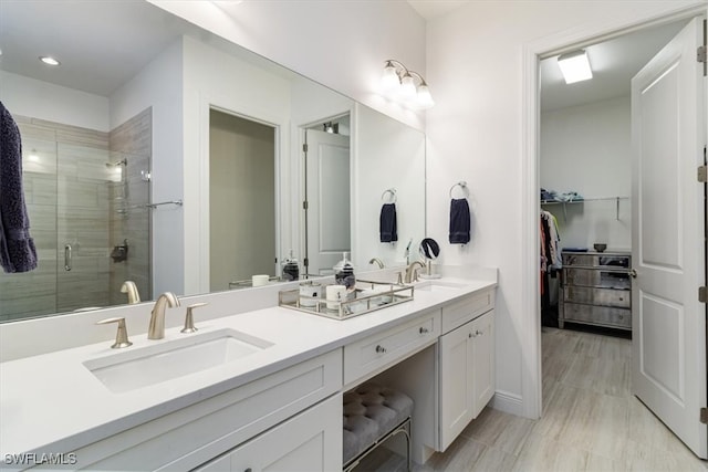 bathroom with vanity and an enclosed shower