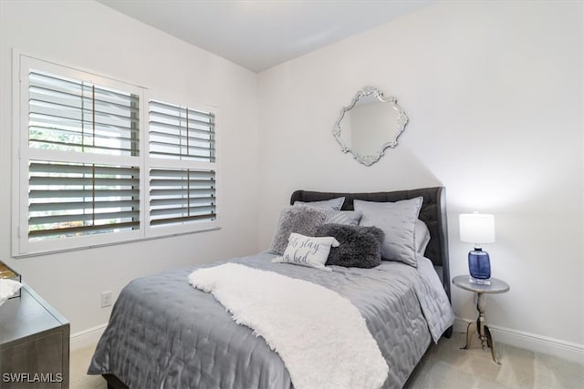 bedroom featuring light colored carpet