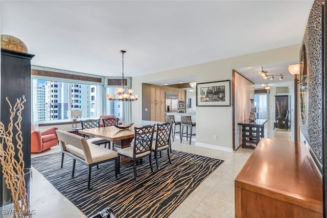 dining area featuring a chandelier and light tile patterned floors