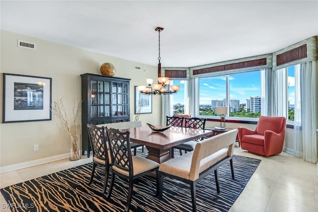 dining room featuring light tile patterned flooring and an inviting chandelier