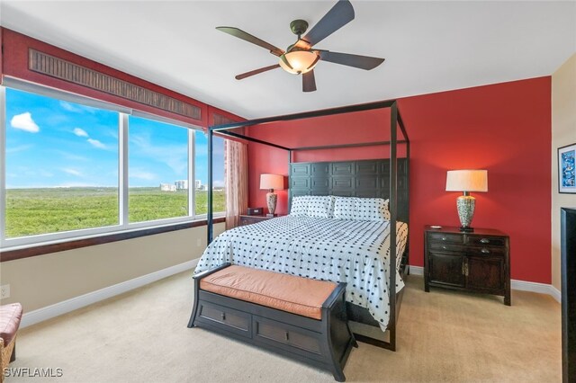 bedroom with ceiling fan and light colored carpet