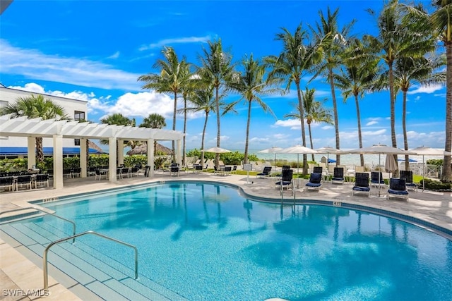 pool featuring a pergola and a patio area