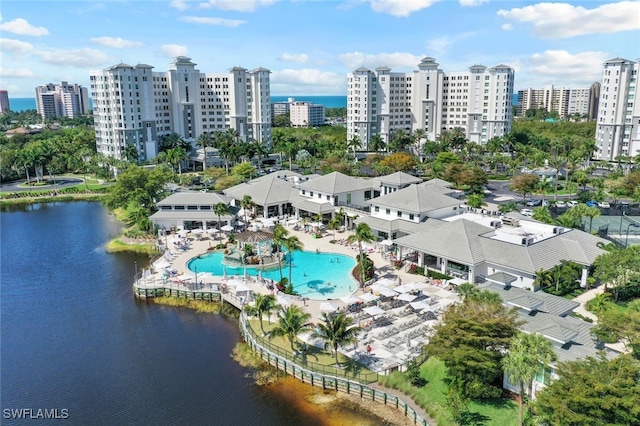 birds eye view of property with a water view and a city view