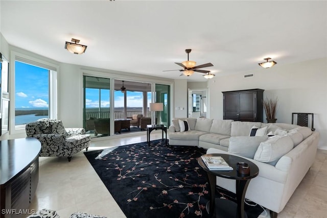 living area with visible vents and a ceiling fan