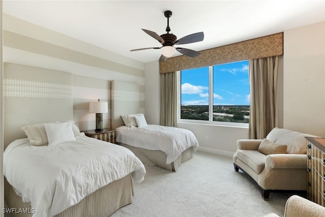 bedroom with baseboards, light carpet, and ceiling fan