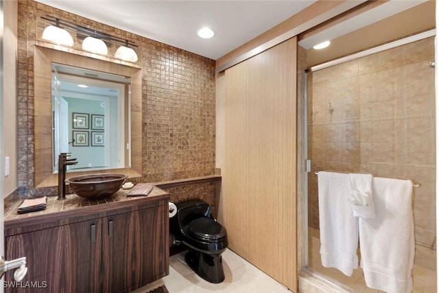 full bathroom with tile walls, a shower stall, toilet, and vanity