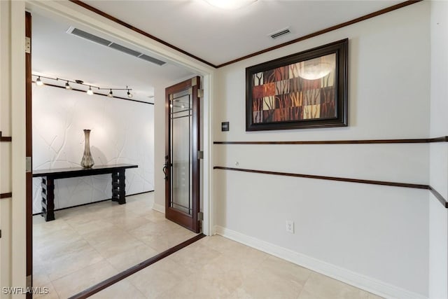 corridor featuring crown molding, visible vents, and baseboards