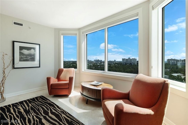 living area featuring visible vents and a city view