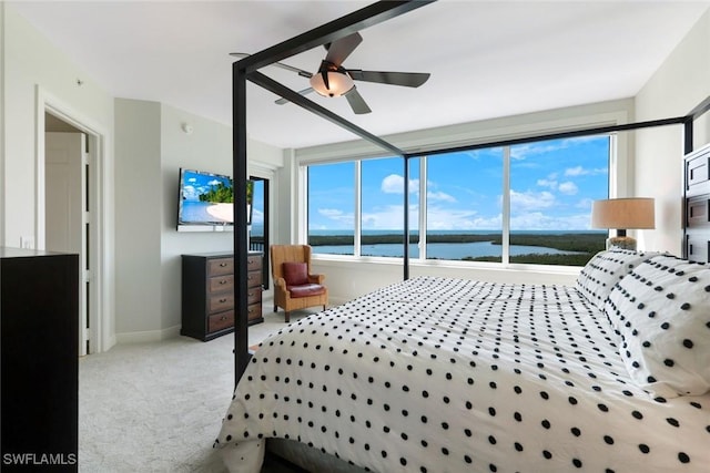 bedroom with ceiling fan, light carpet, and baseboards