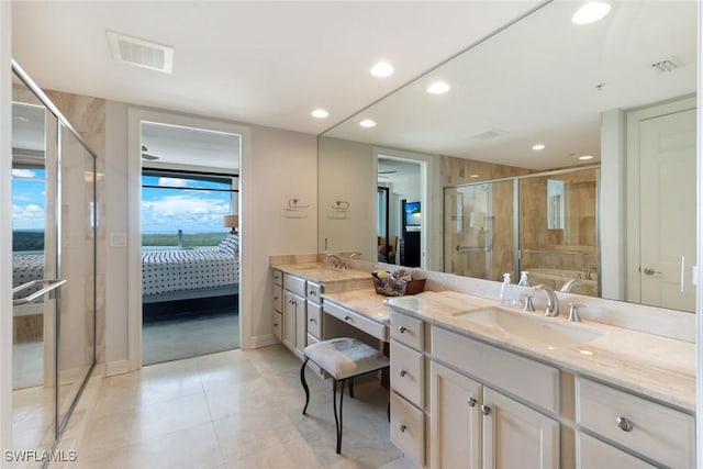 ensuite bathroom with visible vents, a shower stall, ensuite bath, and vanity