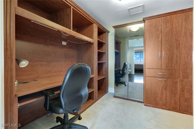 office space featuring visible vents and light carpet