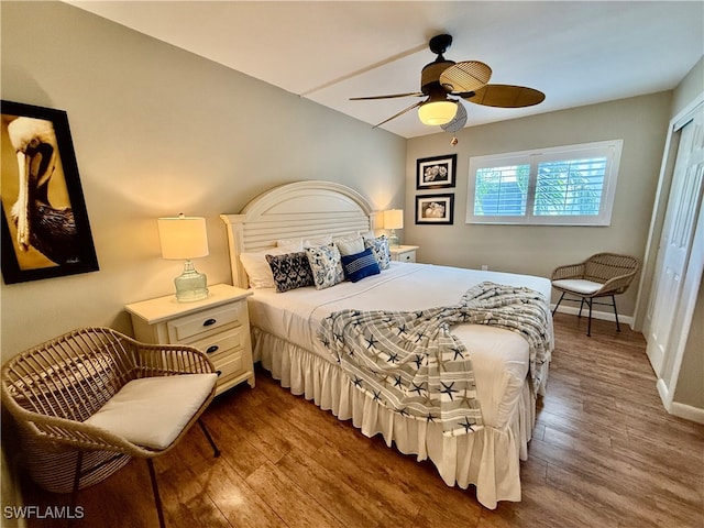 bedroom with ceiling fan, hardwood / wood-style flooring, and a closet