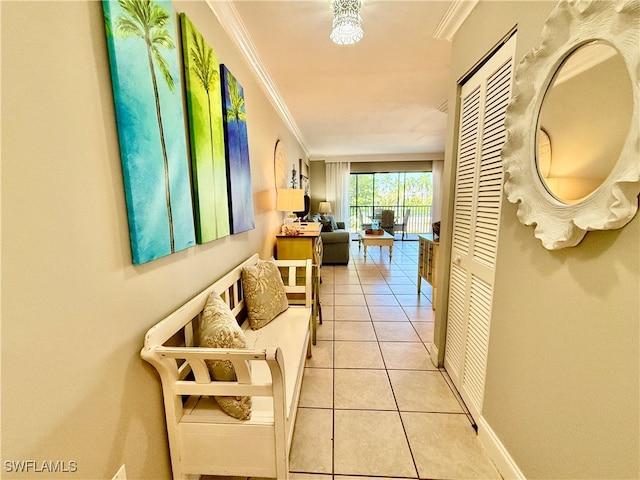 hall with crown molding and light tile patterned floors