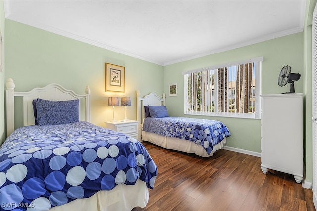 bedroom with ornamental molding and dark hardwood / wood-style flooring