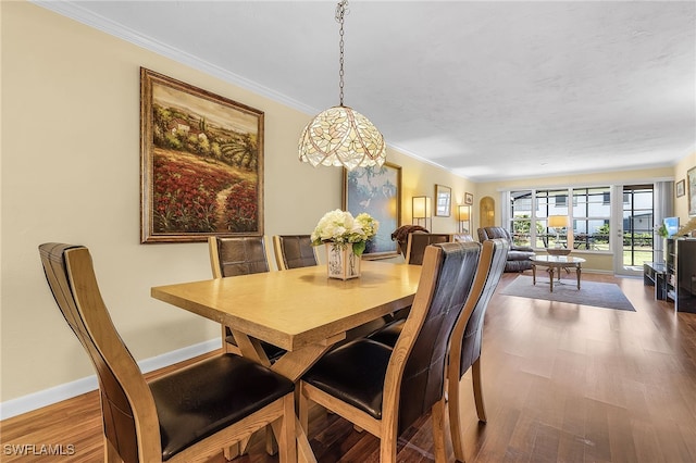 dining room featuring ornamental molding and wood-type flooring